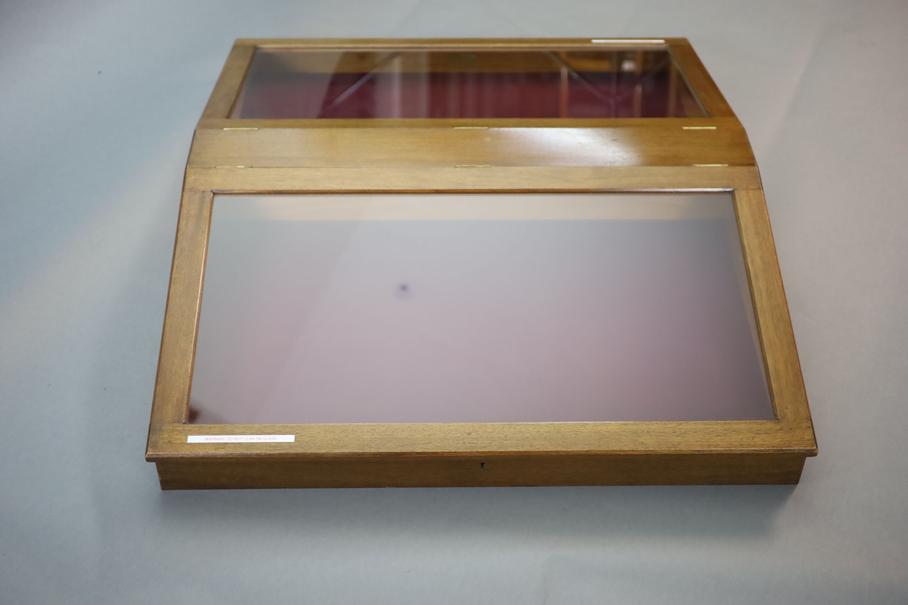 A 20th century teak table top double display case, from the Library of the Royal College of Surgeons, length 125cm width 102cm height 23cm